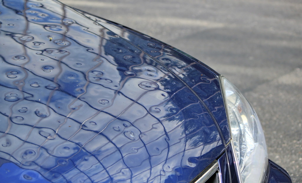 You can buy insurance that will cover damage  at your shop to a customer's car that wasn't your fault, such as hail dents. (Elenarts/iStock/Thinkstock)