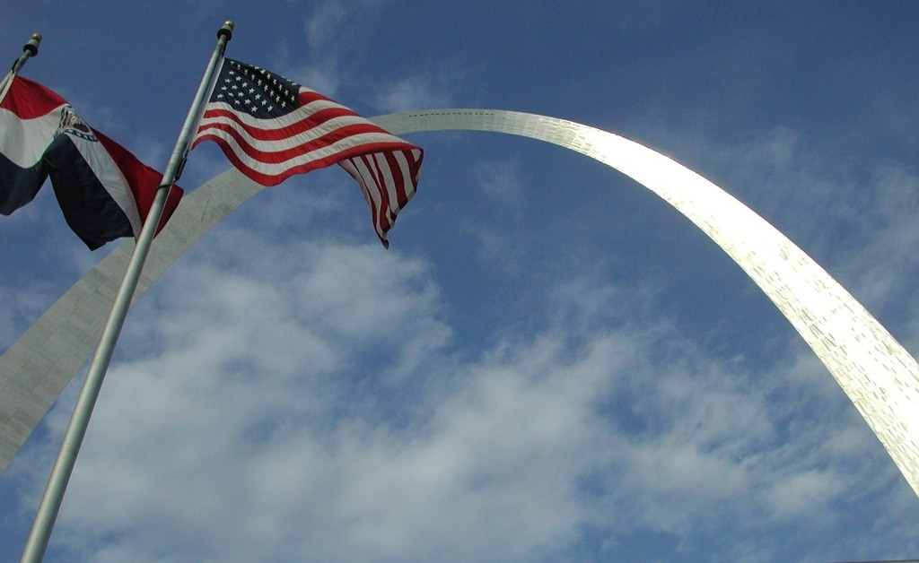 The Gateway Arch is shown with the Missouri and American flags at left in this undated image. (skeeze via Pixabay)