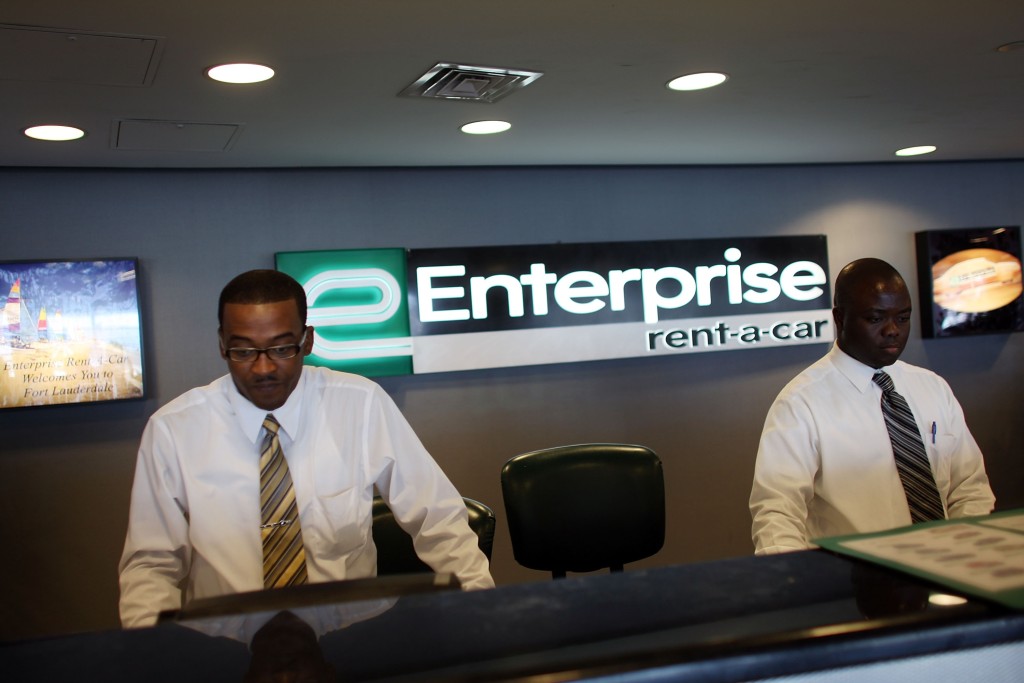Customer service representatives Oneal West, left, and Marmontel Michel wait on customers at Enterprise Rent-A-Car at the Fort Lauderdale/Hollywood International airport July 10, 2007, in Fort Lauderdale, Fla. ( Joe Raedle/Getty Images News file)