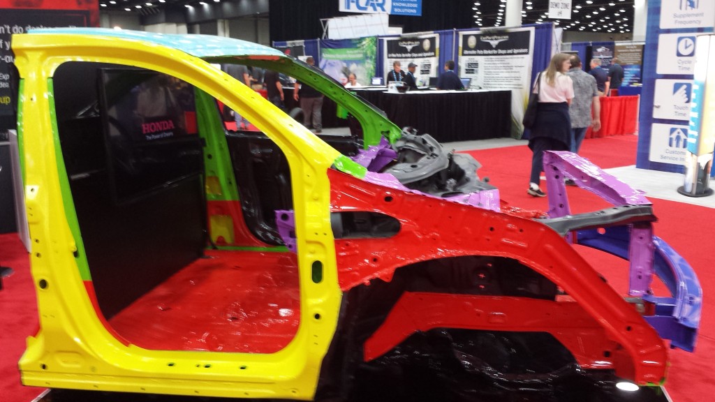 The 1,500-megapascal ultra-high-strength-steel door ring of a 2014 Acura MDX is shown in yellow at the July NACE|CARS show. (John Huetter/Repairer Driven News)