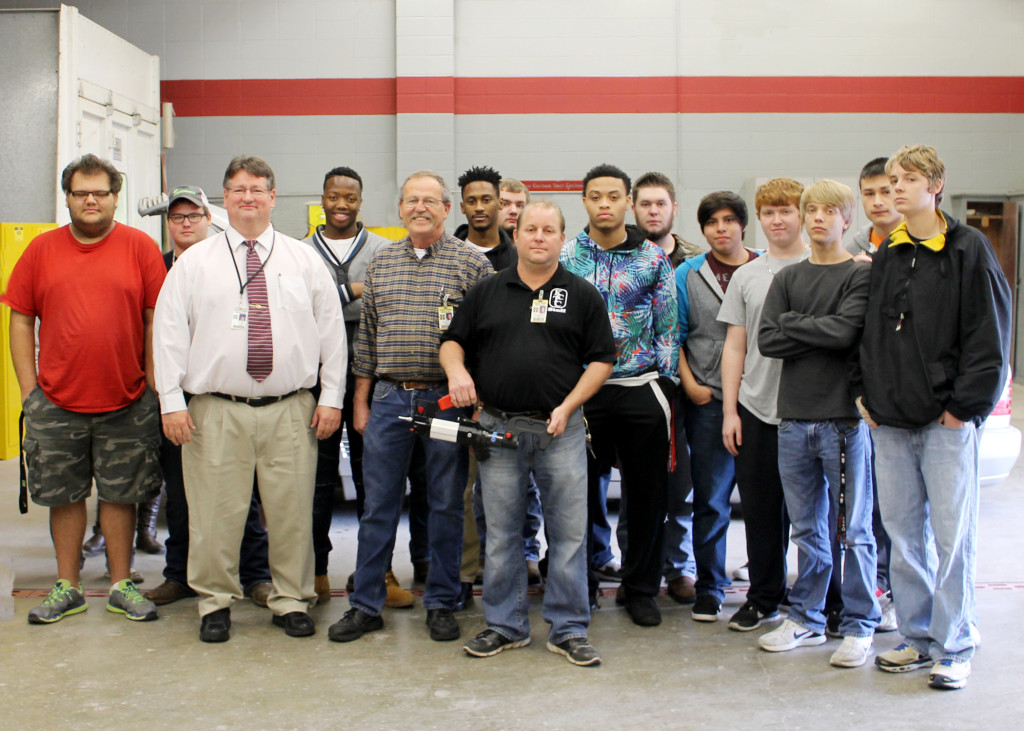 Auto collision and auto technology students and faculty at Kennett Career and Technology Center pose with the Xpress 800 rivet gun won at SEMA. Front row, from left, KCTC Director Terry Bruce, automotive technology instructor Michael Rhew and auto collision instructor Kenneth McKinney.