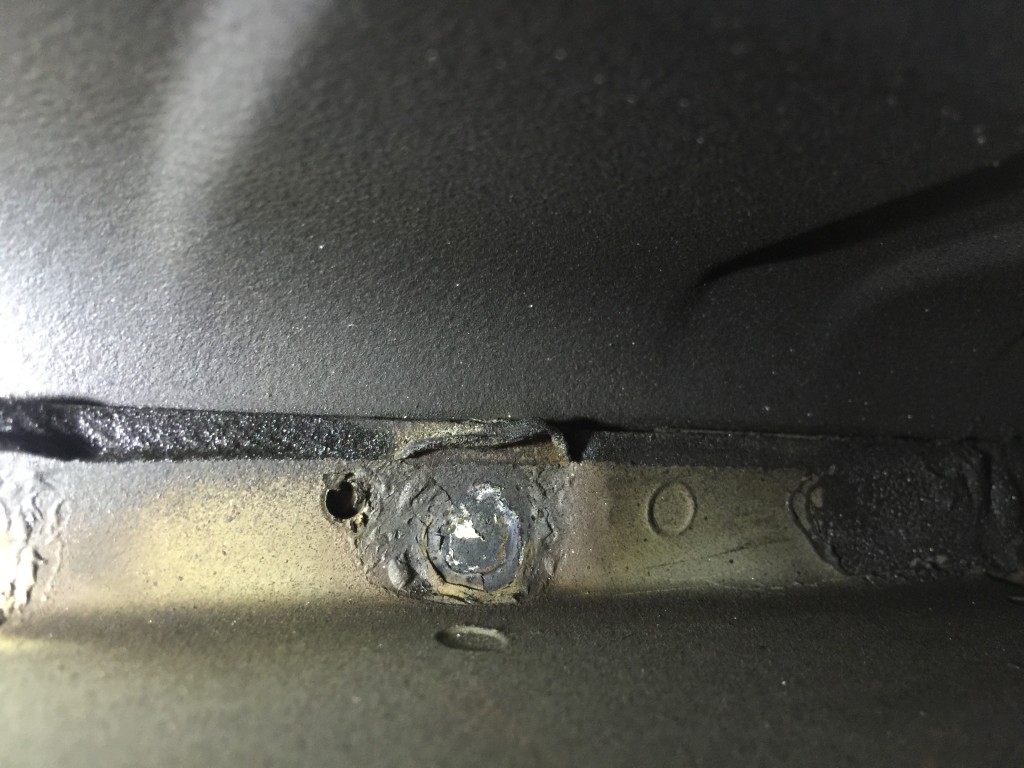Ascue's Auto Body & Paint Shop operations manager Jordan Wooten said this image from a RAV4 floor pan indicates a weld without corrosion protection, an unwelded screw hole, and a factory E-coat which has been burned away. (Provided by Ascue's Auto Body)
