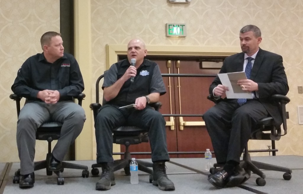 2016 SCRS Repairer Roundtable panelist Jason Bartanen, I-CAR industry technical relations director (there to represent Jaguar Land Rover's program), center, speaks while Tesla body repair program technical manager Kelly Logan, left, and SCRS Chairman Andy Dingman listen. (John Huetter/Repairer Driven News)